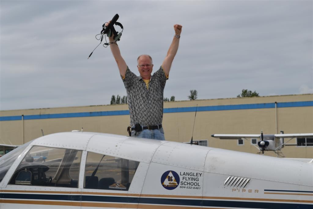 Greg Booker on the wing of Cherokee GCEP after the completion of his First Solo Flight on August 23, 2011.  Langley Flying School