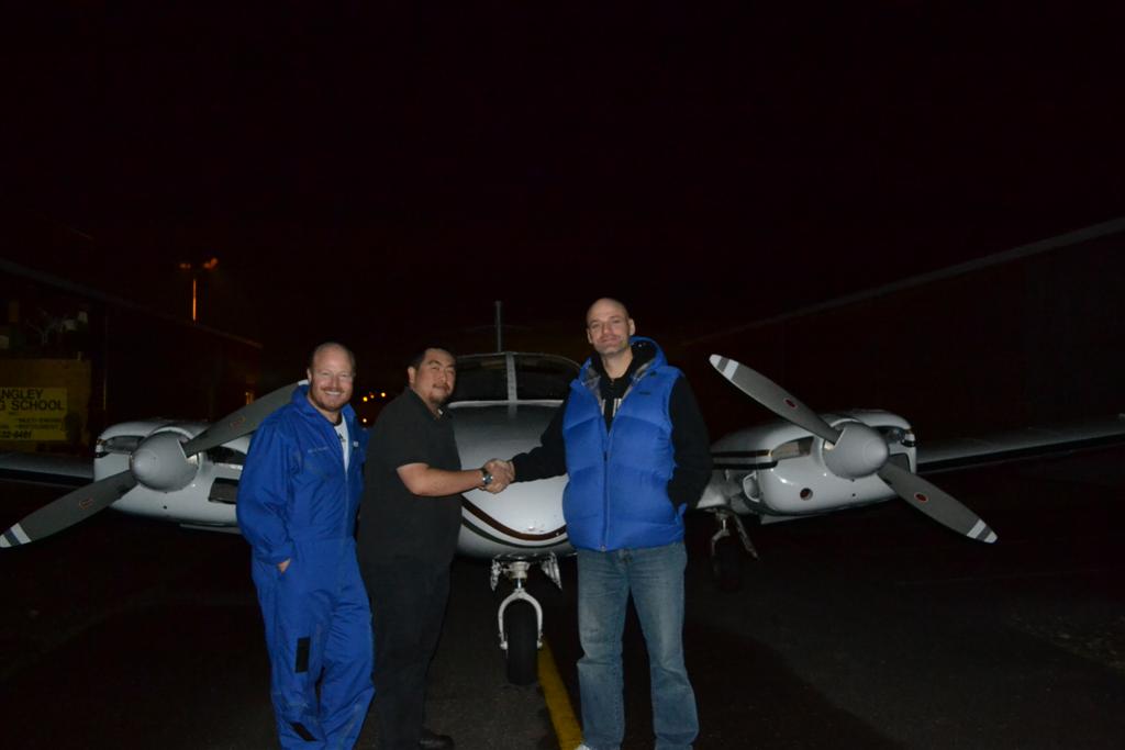 Rick Hunter receives congratulations from Pilot Examiner Todd Pezer and Chief Flying Instructor, Dave Parry after the successful completion of his Group 1 (Multi-engine) Instrument Rating on December 1, 2011. 