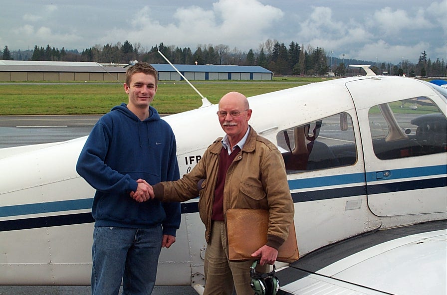 Time Sawatsky receives congratulations from Flight Test Examiner Donn Richardson after the completion of Tim's Commercial Pilot Flight Test.  Langley Flying School.